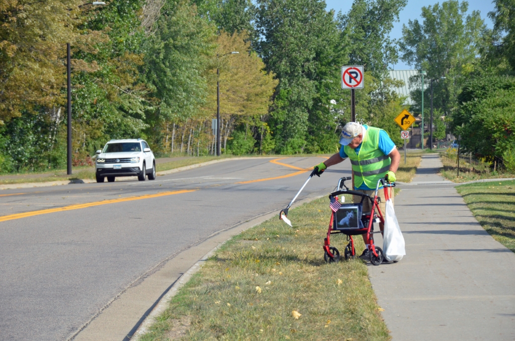 Dick Rawlings picking up trash along Columbine Road.