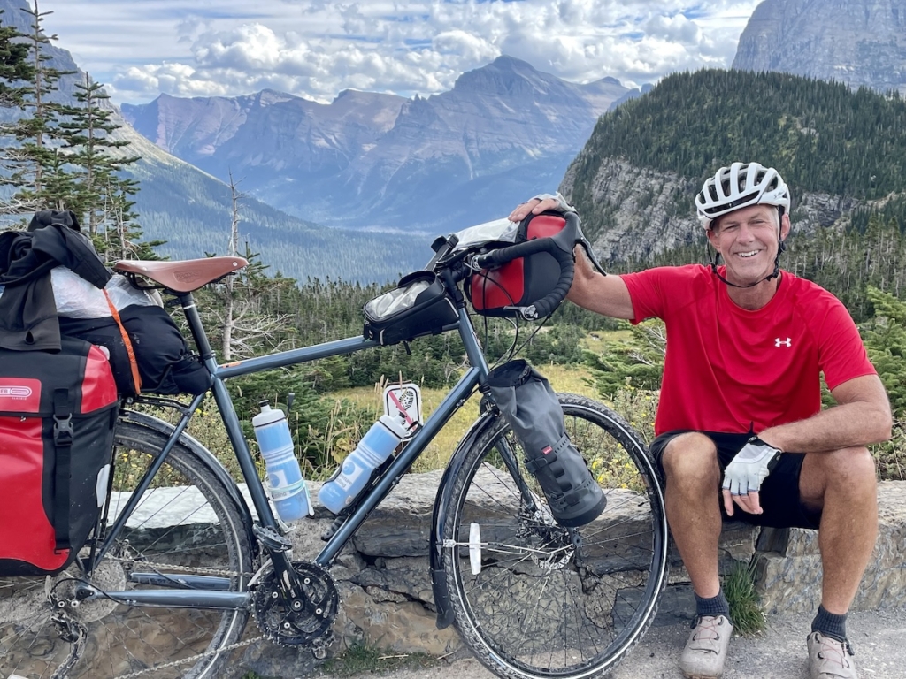 Mike Weinberger pauses from his cross-country bike ride in Glacier National Park.