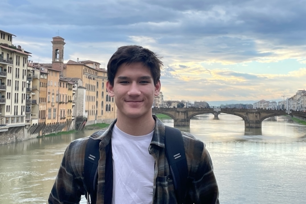 Aaron Husmann posing in front of a bridge in Rome, Italy, in March 2023. Photo courtesy of Thuy Husmann