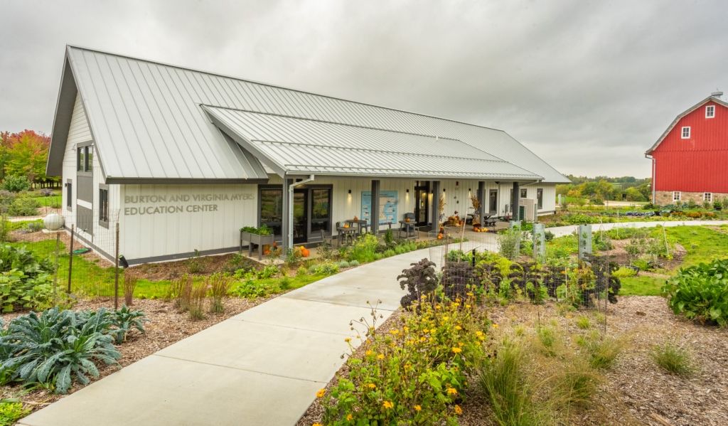 building and barn surrounded by gardens
