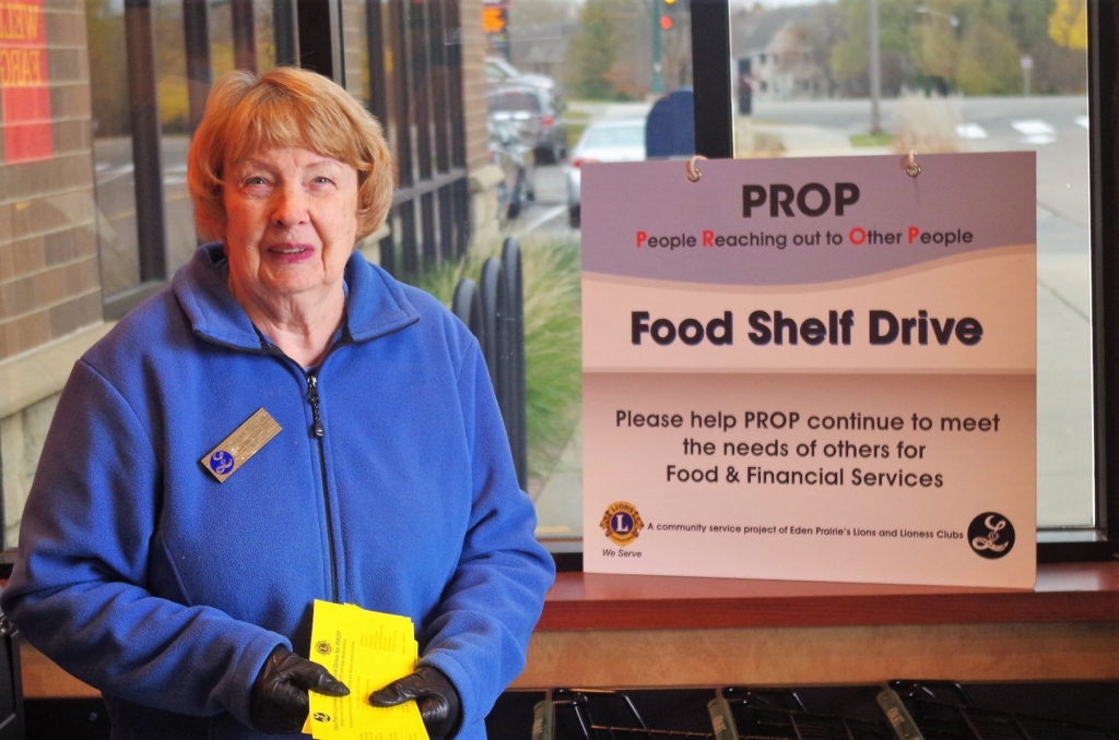 Lioness Lion Shirley Truempi collects food during a past World Service Day. This year's event is set for Oct. 14. Photo by Gary Stevens