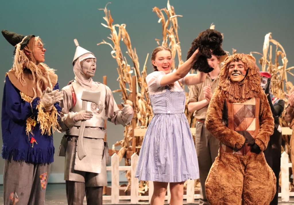 Toto takes a curtain call with Scarecrow, the Tin Man, Dorothy, and the Cowardly Lion. Photo by Emily Yu