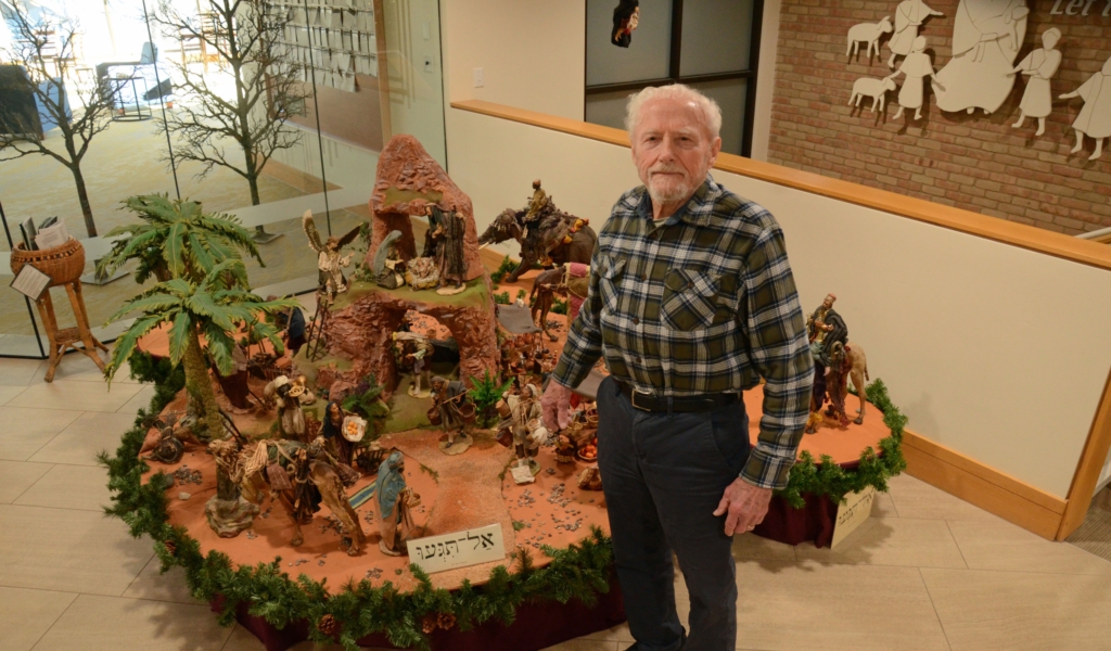 Tom Anderson in front of the crèche that he and wife, Lonnie, first displayed at St. Andrew Lutheran Church in 2020.