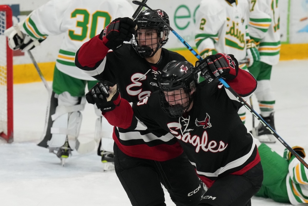 Junior forward Chase Klute (15) of Eden Prairie raises his arms in triumph, having just scored to cut Edina's lead to 2-1. Teammate Mason Moe (19), a sophomore forward, is behind him, sharing in the celebration. Photo by Rick Olson