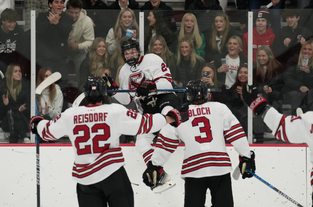 Eagles senior forward Dawson Miller (center) celebrates with teammates Ben Reisdorf and Tate Bloch after scoring against Wayzata, giving the team a 1-0 lead Friday night at Eden Prairie Community Center. Photo by Rick Olson