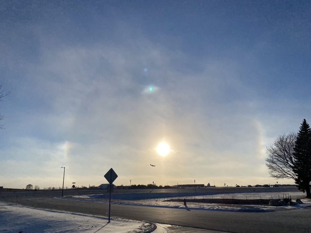 Plane landing in front of a sun dog at 3:50 p.m. on Jan. 15, 2024 across from Flying Cloud airport. Photo by Juliana Allen