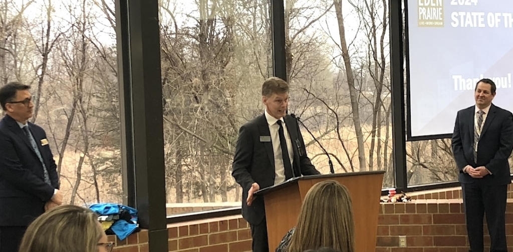 Eden Prairie City Manager Rick Getschow, Eden Prairie Chamber of Commerce President Pat MulQueeny, and Eden Prairie Schools Superintendent John Swanson shared the stage at the January 2024 State of the City event. Photo by Joanna Werch Takes