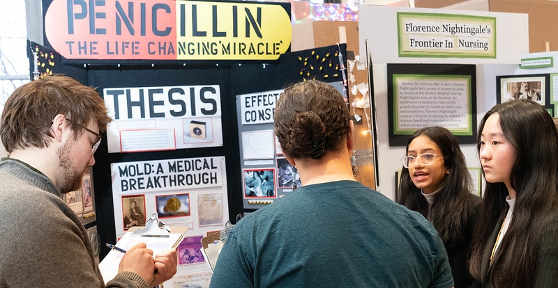 Judges interviewing students about their exhibits. Photo by National History Day in Minnesota