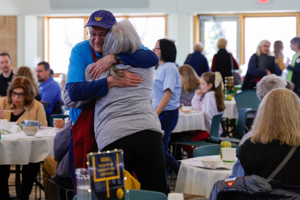 Rich Weaver, a kitchen volunteer for Empty Bowls, hugs Gayle Benson, a former Eden Prairie resident he hasn't seen for years. "That is one of the neat things with Empty Bowls — it brings people together," Weaver said.