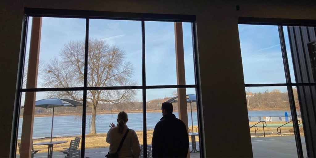 Eden Prairie Parks Director Amy Markle and Parks and Natural Resources Manager Matt Bourne look out the giant windows of the community room that anchors a new facility at Round Lake Park. Photos by Mark Weber