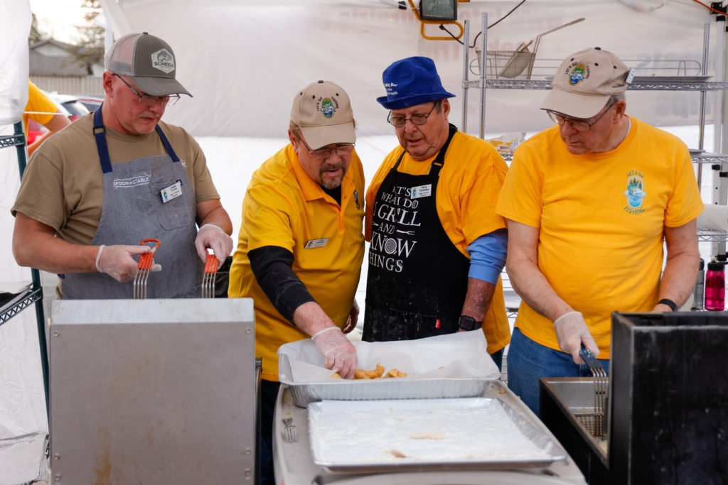 (From left) Dean Trom, Bill Adams, Terry Toomey and John Goergen at the Let’s Go Fishing – Eden Prairie annual fish fry in 2024. Photo by Gillian Holte