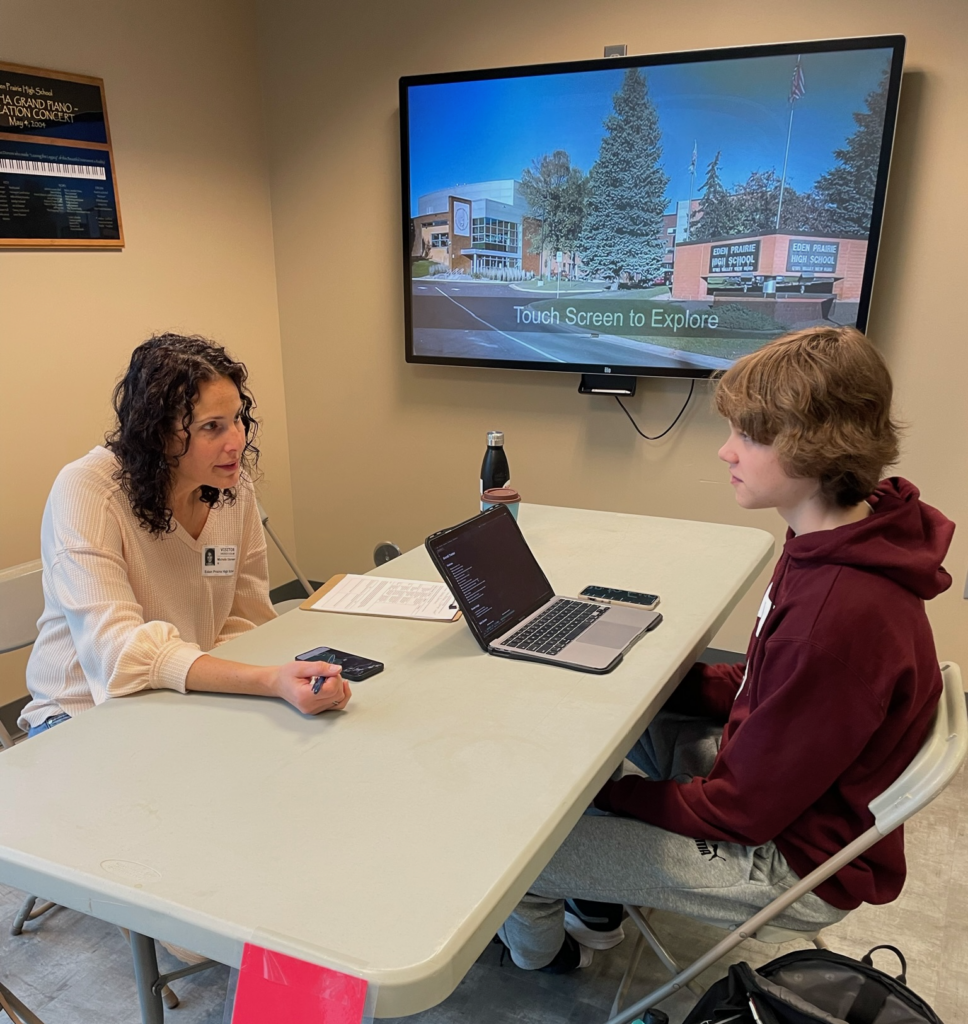 Volunteer Michelle Diermeier talking with an EPHS iOS Mobile App Development student during a feedback session last year. Contributed photo