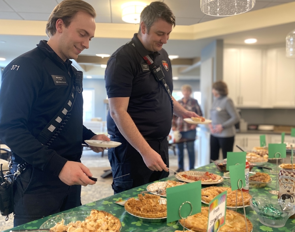 Eden Prairie fire inspectors Rob Cross (left) and Dave Shephard help themselves to pie during the Pi Day celebration at Applewood Pointe of Eden Prairie on Thursday, March 14. Photos by Stuart Sudak
