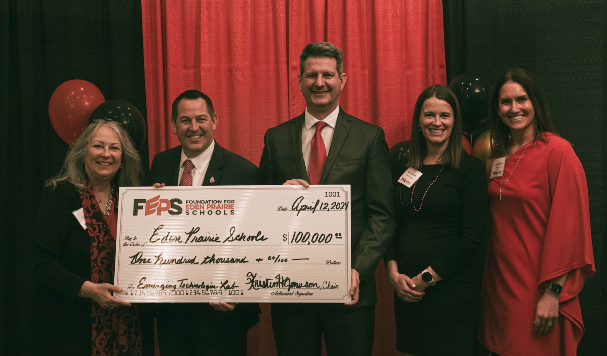 FEPS presented Eden Prairie Schools with an oversize $100,000 check. (L-R) FEPS Exec. Director Lisa Sisinni, Superintendent Josh Swanson, EP School Board Member CJ Strehl, FEPS Board Chair Kristin Jonason, FEPS Board Member Anna Anderson. Photo by Sheldon Powell 