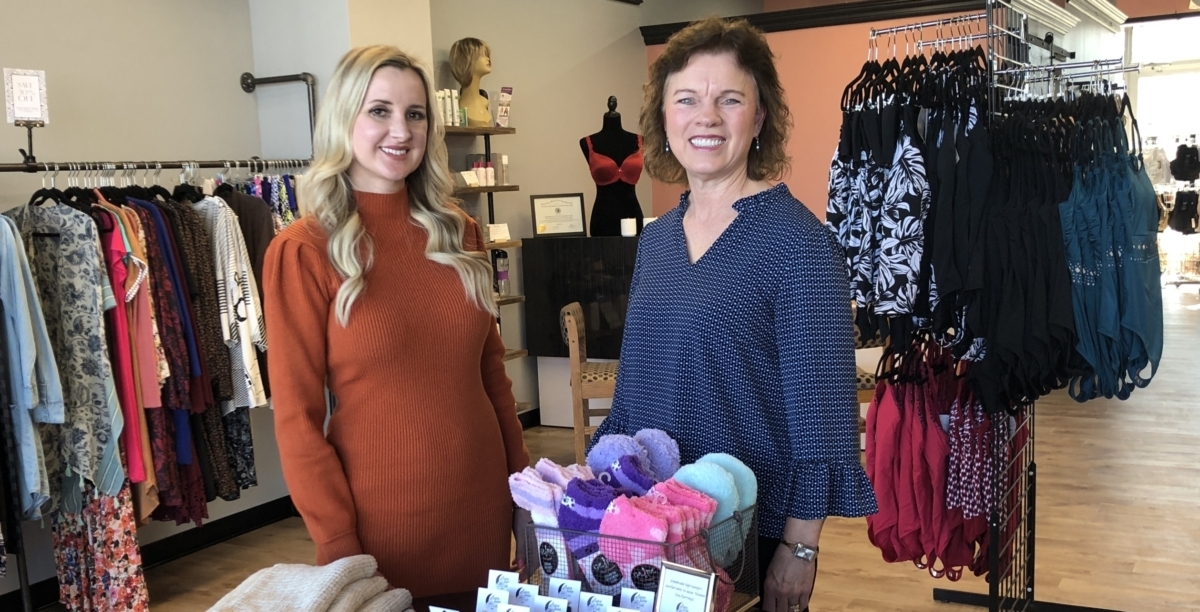 2 women standing in retail store setting