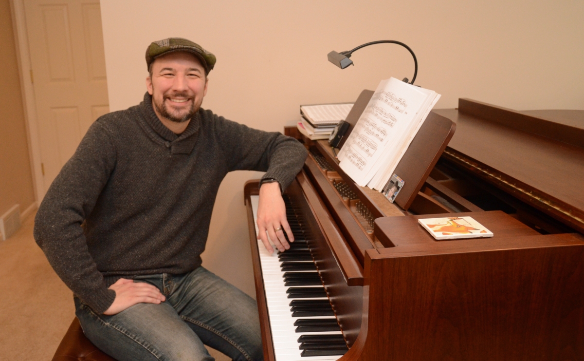 David Cavalari poses with his piano in the master bedroom of his Eden Prairie home. Photo by Jim Bayer