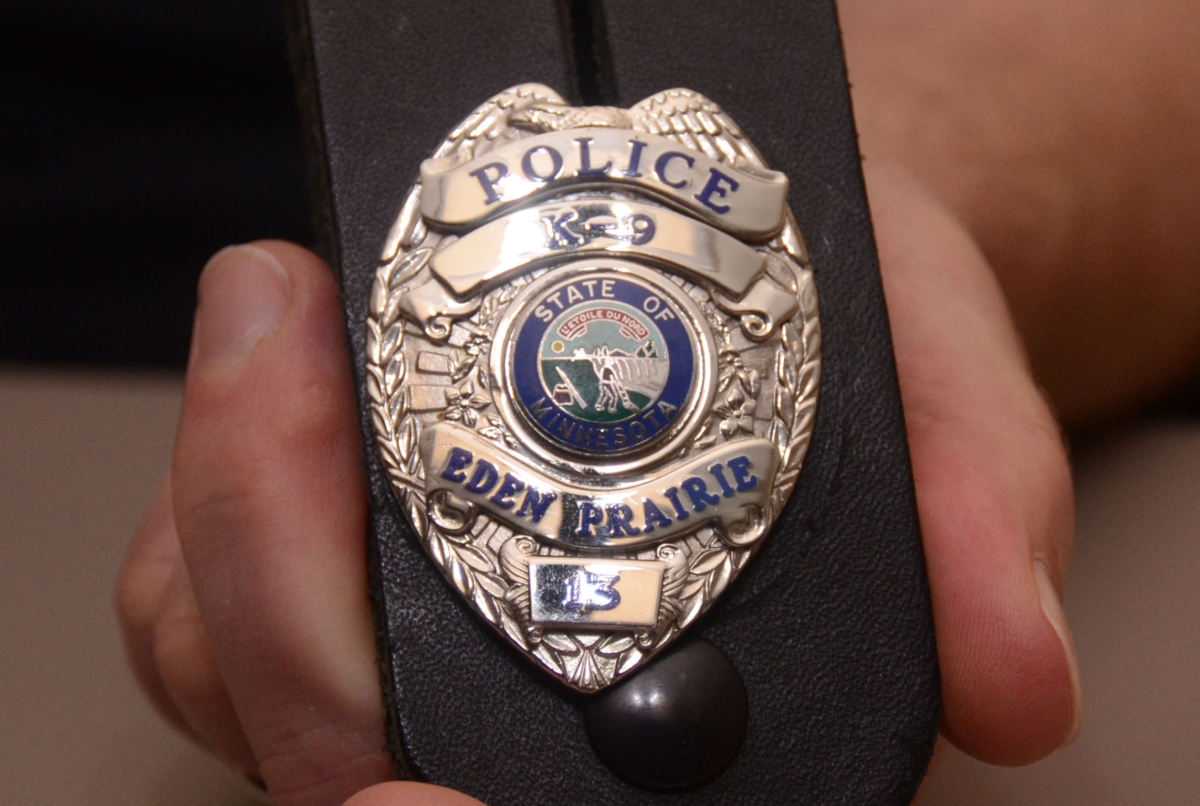 EPPD Sgt. Scott Mittelstadt holds K9 officer Riggs badge #13. Riggs died May 3 at age 11. Photo by Jim Bayer