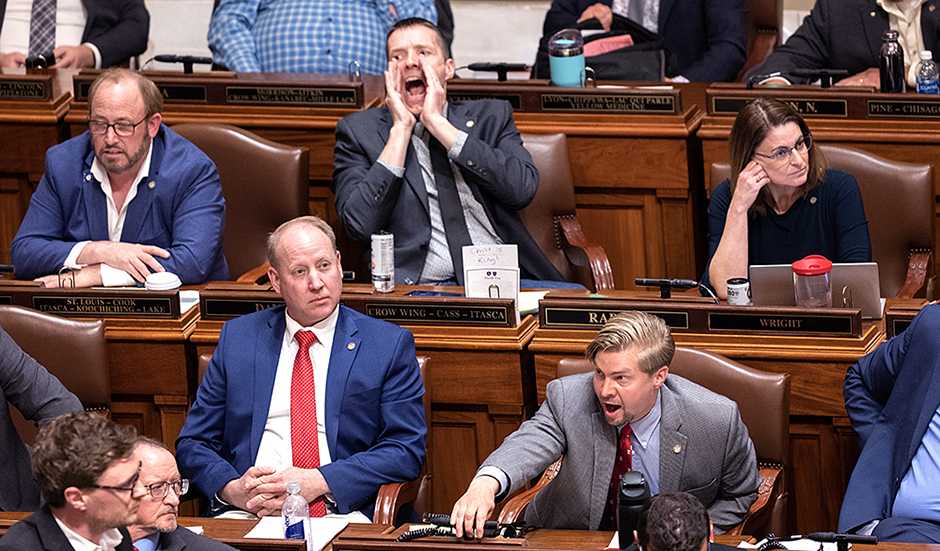 State Rep. Ben Davis, center back, and Rep. Harry Niska, lower right, yelling at the end of the session. MinnPost photo by Tom Olmscheid
