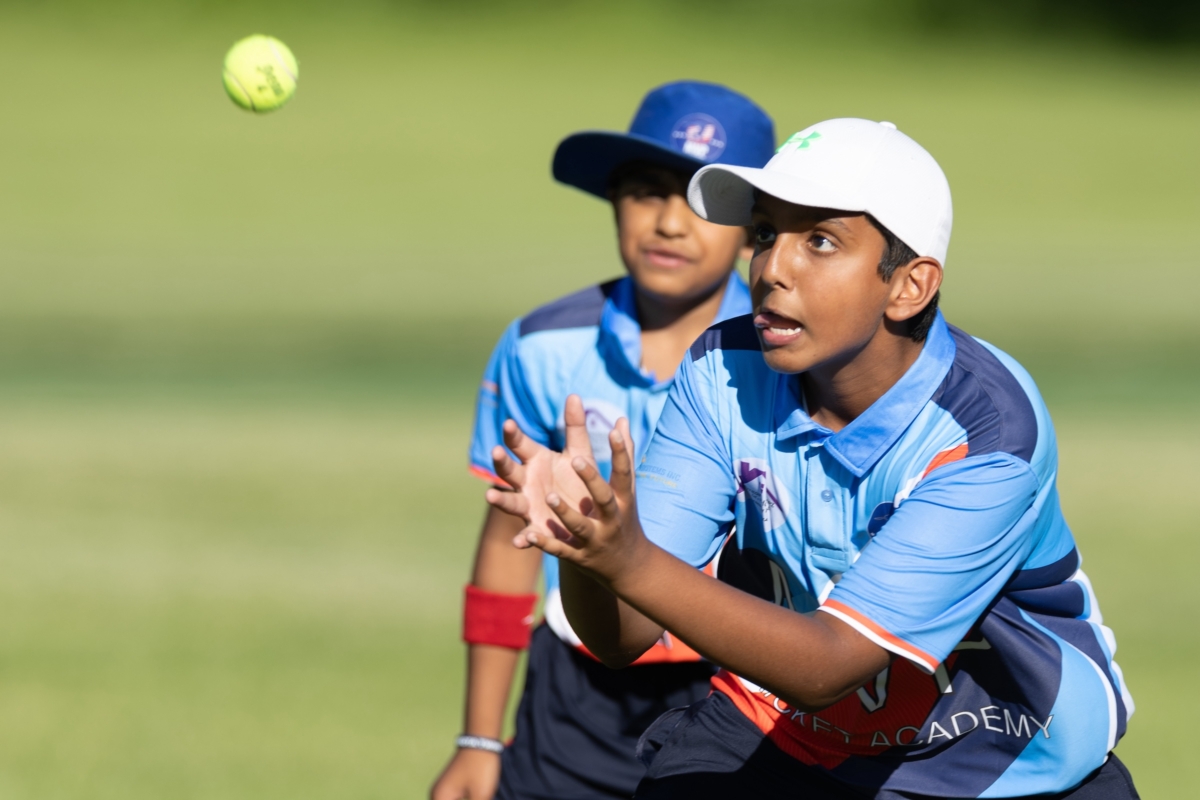 A member of the MVP Cricket Academy concentrates on catching a ball while another cricketer watches during the Eden Prairie Community Cricket Night at Nesbitt Preserve Park on June 13. Photo by Jeff Lawler