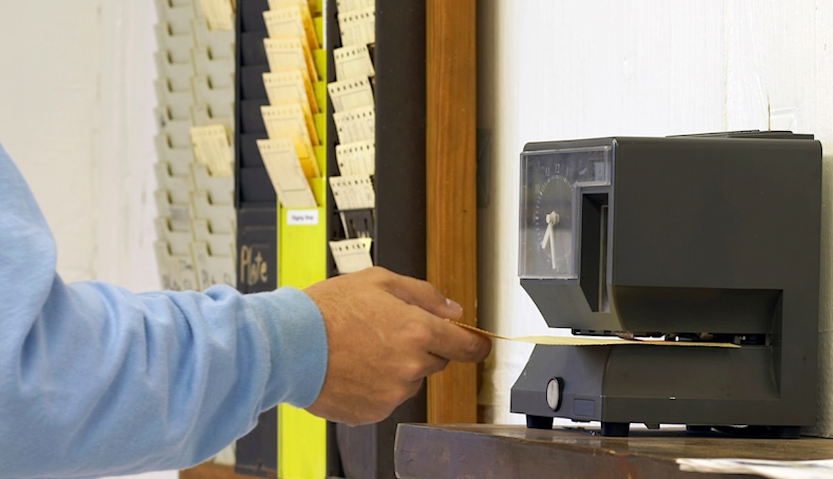 Punching the clock. Adobe Stock Image