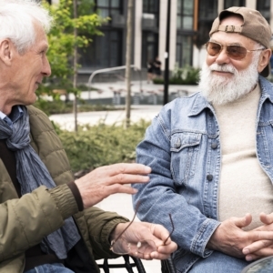 Two elderly men chatting together