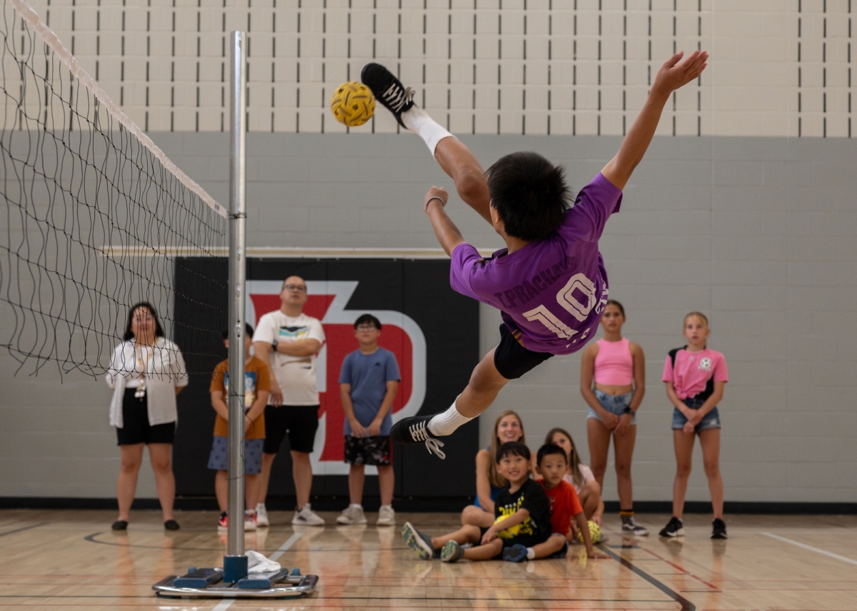 Meng Xiong from Sepak Takraw of USA, Inc. shows off his acrobatic skills while striking the ball over the net with his foot. Photos by Jeremy Peyer
