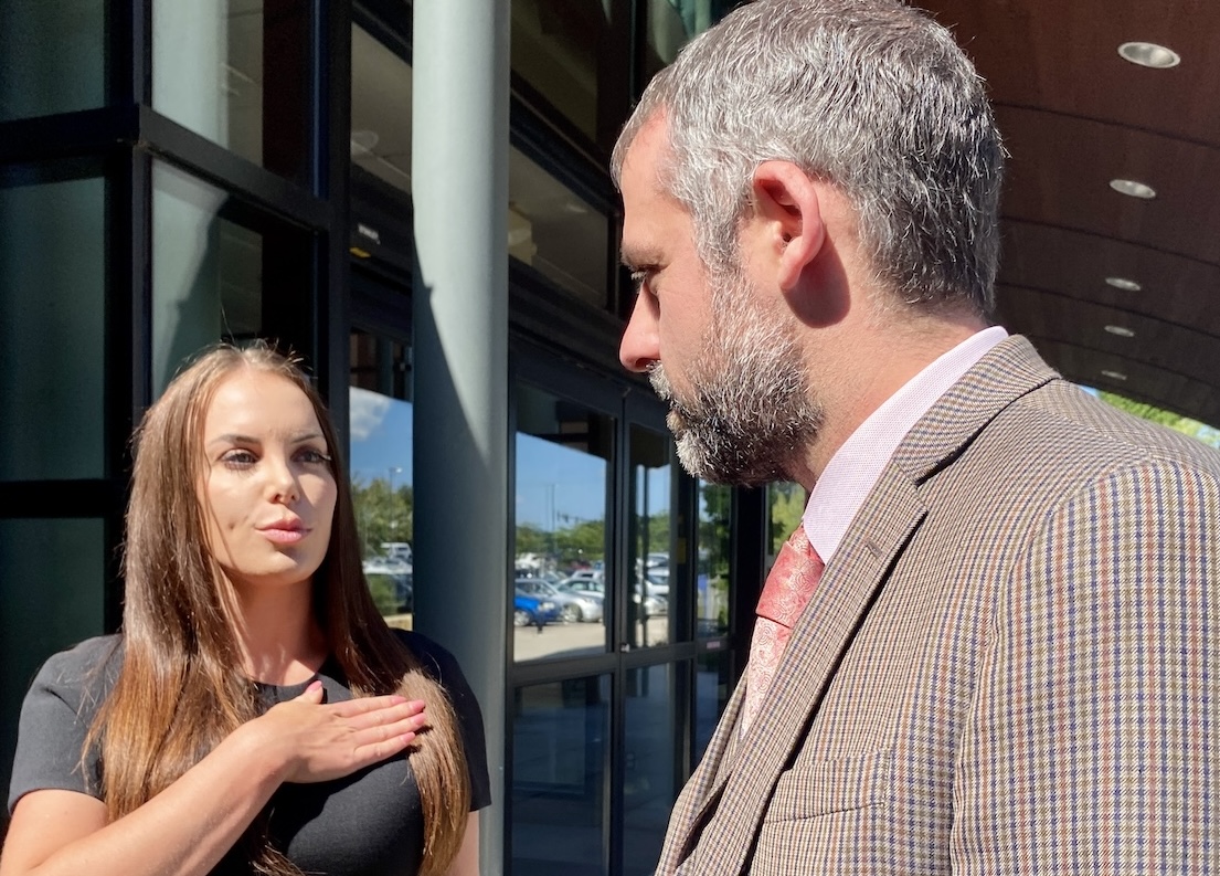Marisa Simonetti (left) and her attorney, John T. Daly, speak with KARE 11 reporter Lou Raguse outside the Hennepin County Ridgedale Regional Center in July. Simonetti, a candidate for District 6 Hennepin County commissioner, faces a fifth-degree assault charge. File photo by Stuart Sudak