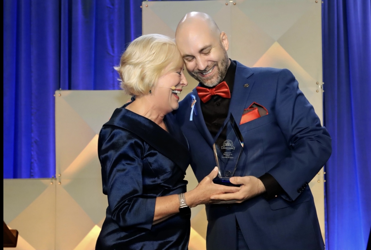 Barbara M. Hunter, NSPRA's executive director, presenting Dirk Tedmon with his 2024 National School Communicator of the Year award. Contributed photo