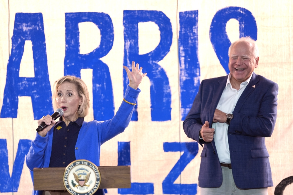 FILE - Democratic vice presidential nominee Minnesota Gov. Tim Walz, right, listens as his wife Gwen Walz speaks at a campaign event, Aug. 18, 2024, in Rochester, Pa. (AP Photo/Julia Nikhinson, File)