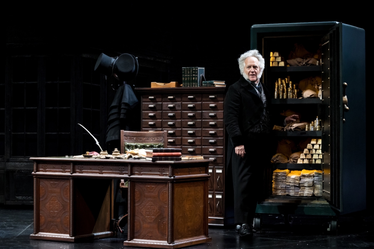 David Beach as Ebenezer Scrooge surveys his wealth, a symbol of his greed and isolation.
Photo by Dan Norman