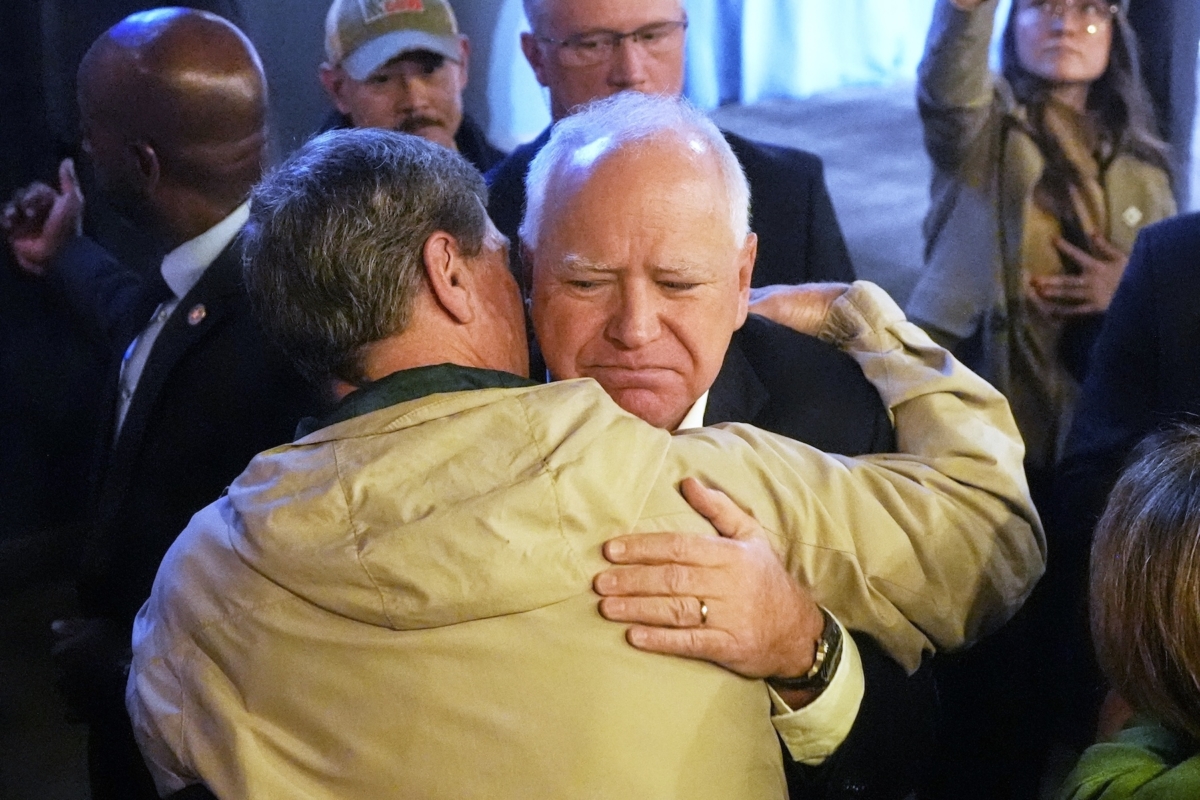 Democratic vice presidential nominee Minnesota Gov. Tim Walz, right, hugs former Rep. Ron Kind, D-Wis., after speaking at a campaign stop Monday, Nov 4, 2024, in LaCrosse, Wis. (AP Photo/Morry Gash)