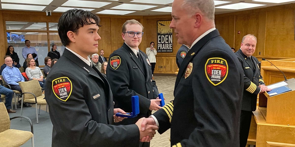 Firefighter Michael Do, left, is congratulated by Assistant Fire Chief Rik Berkbigler for receiving the fire department’s highest recognition, the Award of Honor. Looking on are firefighter Joshua Privette, center, and Fire Chief Scott Gerber, right. Photo by Mark Weber