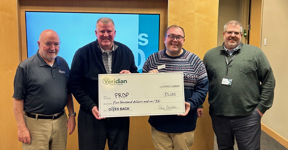 Matt Dymoke of PROP food shelf, third from left, receives a donation check from Veridian Credit Union employees Dennis Dickinson, Tom Fleck and Brock Kouba. Submitted photo