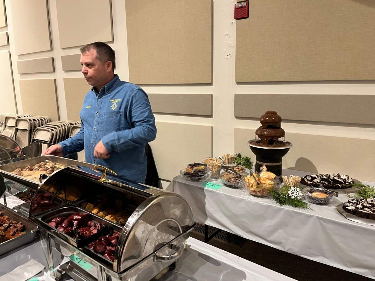 man in blue denim shirt as food line server