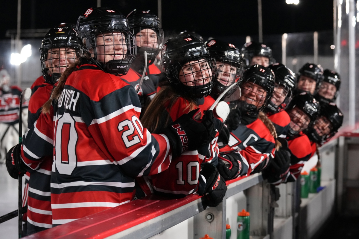 Eden Prairie's Cora Bukovich (20) and Allie Dahl (10) enjoy their Hockey Day Minnesota victory over Prior Lake at Valleyfair on Thursday. Photo by Rick Olson