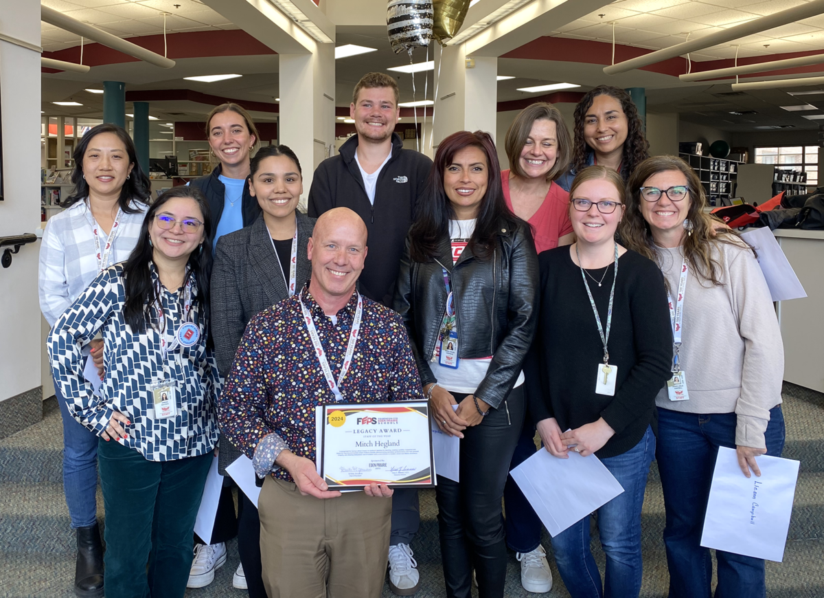Mitch Hegland (pictured center), the associate principal of Eagle Heights Spanish Immersion, won the Staff of the Year award in 2024. Photo contributed by Foundation for Eden Prairie Schools