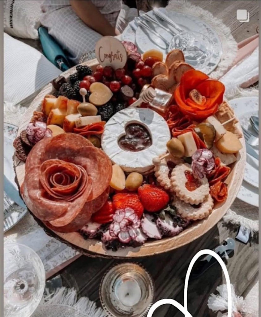 A photo of a tray of heart shaped charcuterie