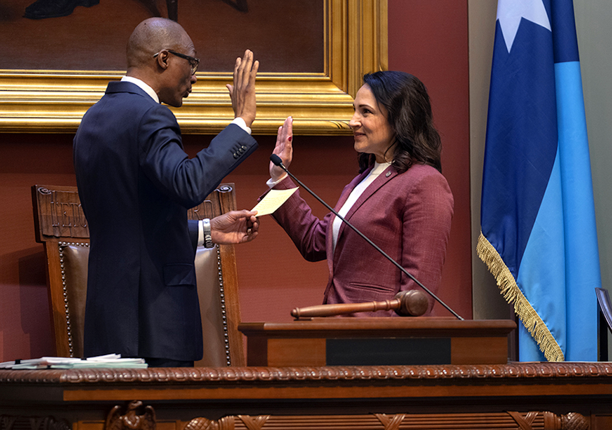 President of the Senate Bobby Joe Champion, left, swears in Rep. Lisa Demuth, right, to be the next Speaker of the House on Thursday. MinnPost photo by Tom Olmscheid