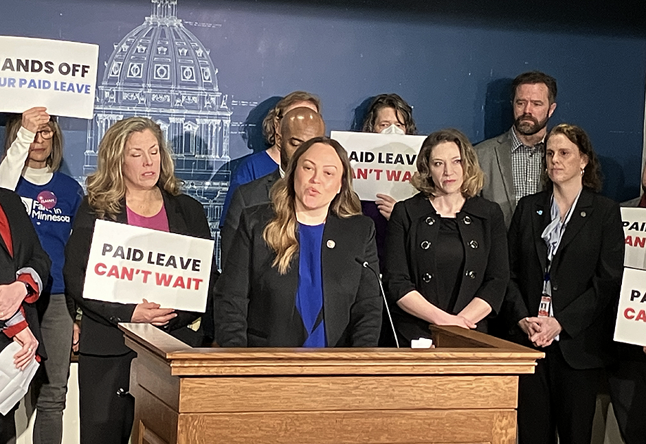 State Sen. Alice Mann, center, the prime sponsor of paid family and medical leave, defending the program at a Monday press conference.