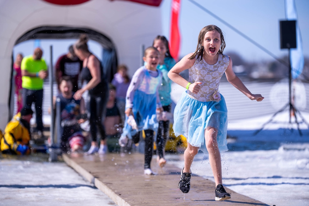 Polar Plunge, Little girl runs down the dock after plunging, Lake Riley
