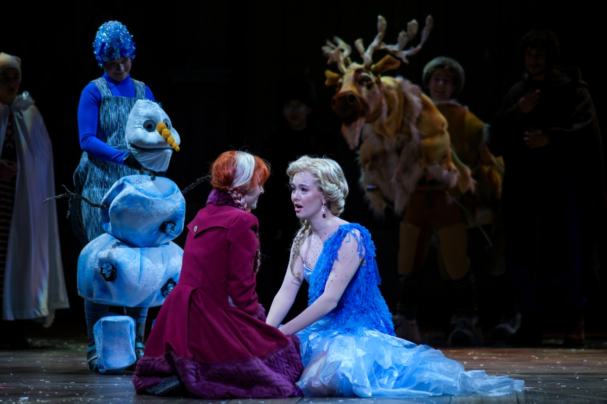 Anna (Julia Ennen) and Elsa (Gillian Jackson Han) reconnect in an emotional moment, watched by Olaf (Laura Marie) and Sven (Adam Jones), in Children’s Theatre Company’s production of “Frozen.” Photo by Glen Stubbe Photography