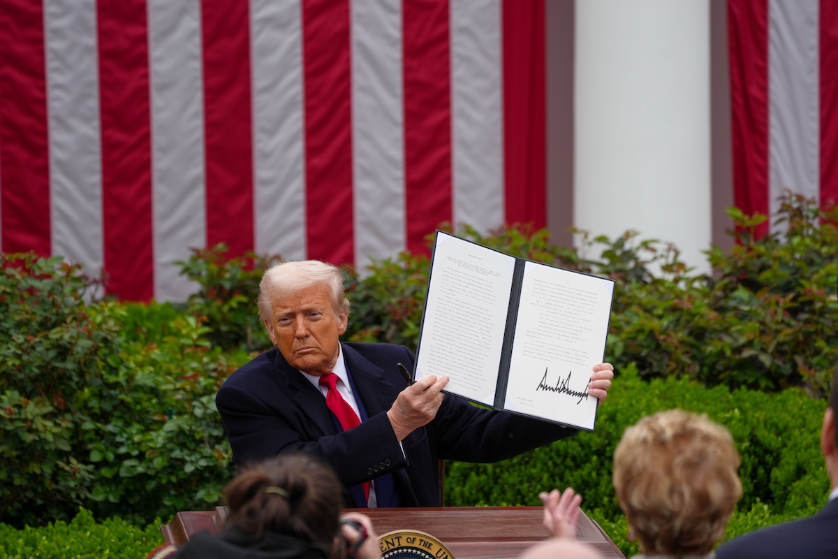 Donald Trump signs an executive order to start reciprocal tariffs on many other nations, effective at midnight, on April 3, 2025. (Photo by Andrew Leyden/NurPhoto)NO USE FRANCE