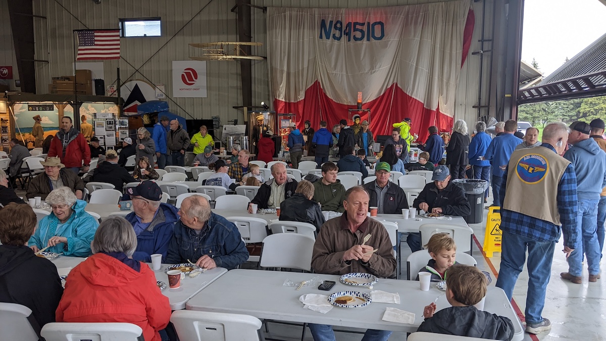 Guests enjoy breakfast inside the Wings of the North hangar during the spring 2024 Pancake Breakfast at Flying Cloud Airport in Eden Prairie.