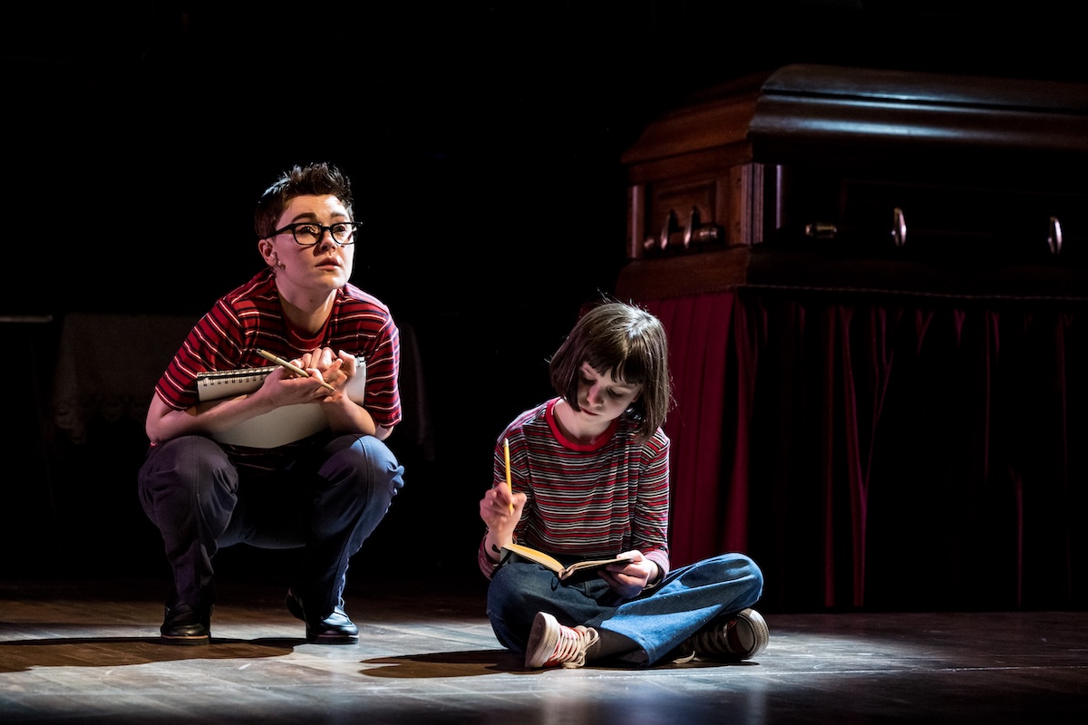 (From left) Sara Masterson as Alison and Eve Scharback as her younger self, Small Alison, share a quiet moment in “Fun Home,” sketching memories that shape their future selves.