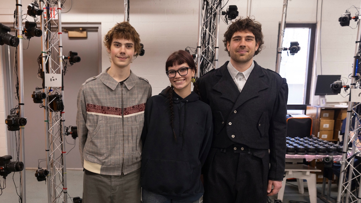 3 young people pose in digital photography lab