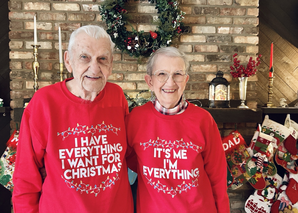 Jerry and Cecelia (Cece) McCarty wear holiday sweatshirts that sum up their long, happy marriage.