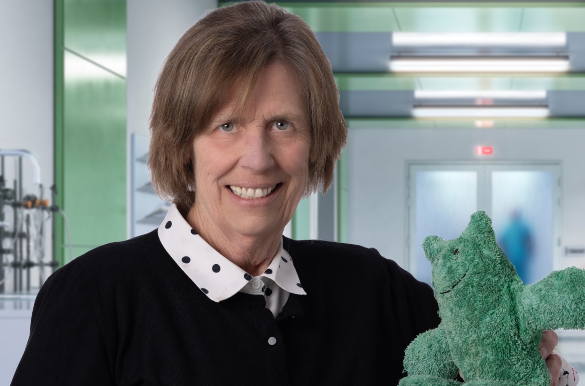 Marilou Pederson, a founder of All About Children Pediatrics, holds Izzy, the clinic’s green mascot created by a young patient.