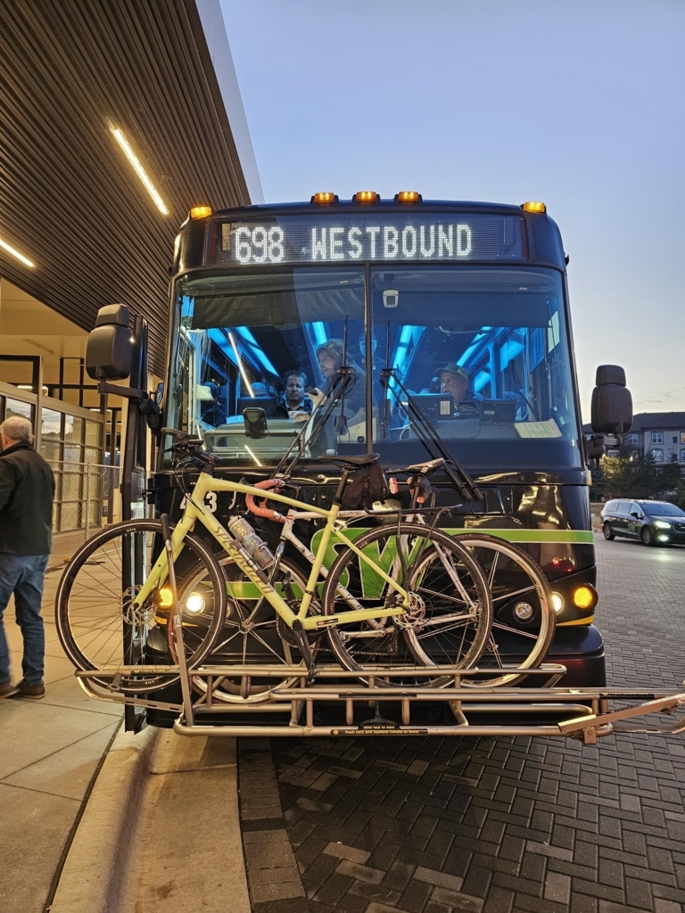 the front of a bus showing several bicycles mounted to it on a rack