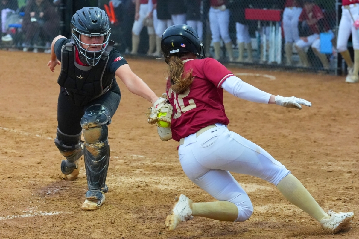 Eden Prairie senior catcher Noelle Fitzgerald (29) tags out a Maple Grove runner at the plate to end the top of the third inning Friday at Miller Park. The Eagles went on to win their regular-season finale 7-1.