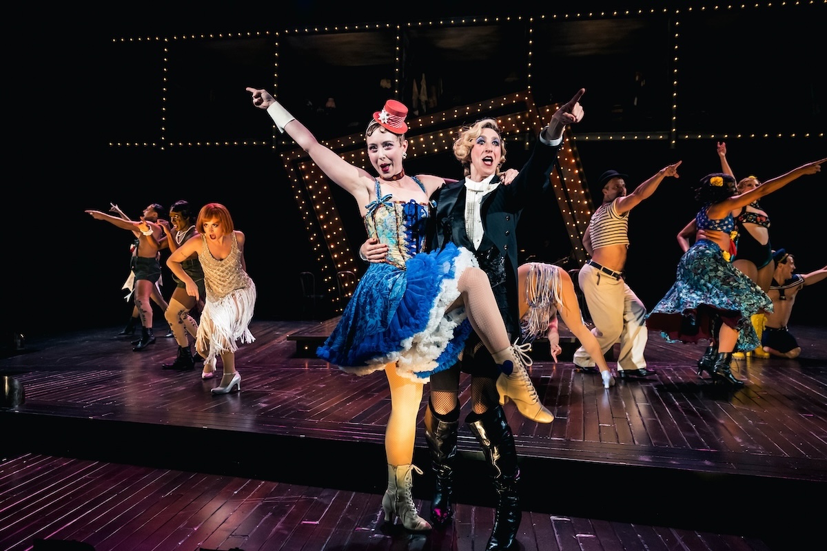 Jo Lampert, right, stars as the Emcee alongside Kit Kat Klub dancers in the Guthrie Theater’s production of “Cabaret.” Pictured with Lampert is ensemble member Elly Stahlke.